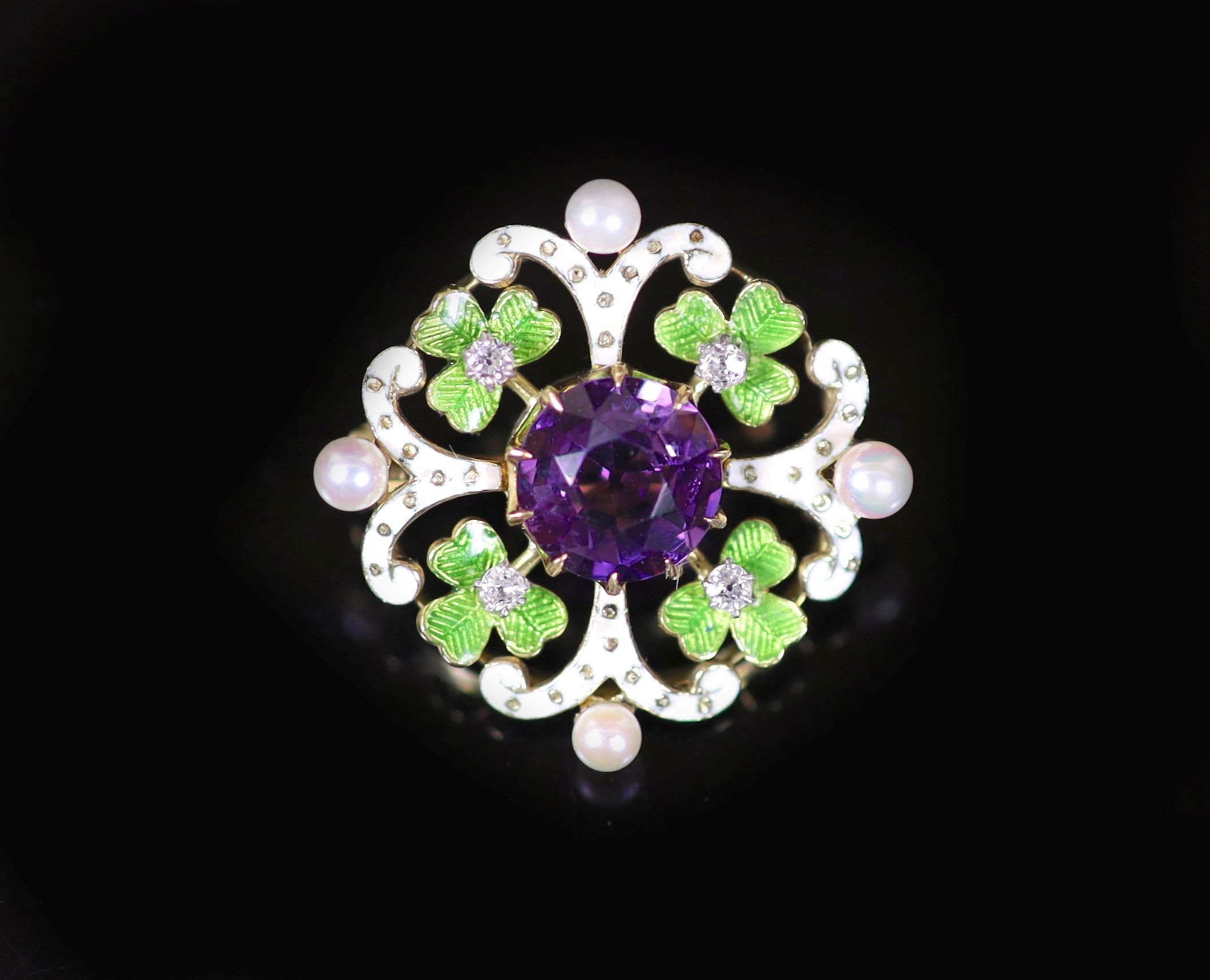 An early 20th century pierced gold, amethyst, seed pearl, green and white enamel set circular brooch, in the Suffragette colours
